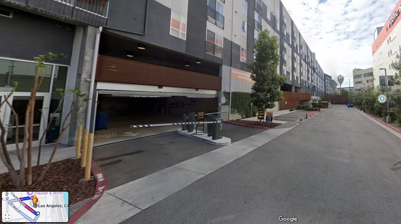 Urban street view with modern buildings and parking entrance