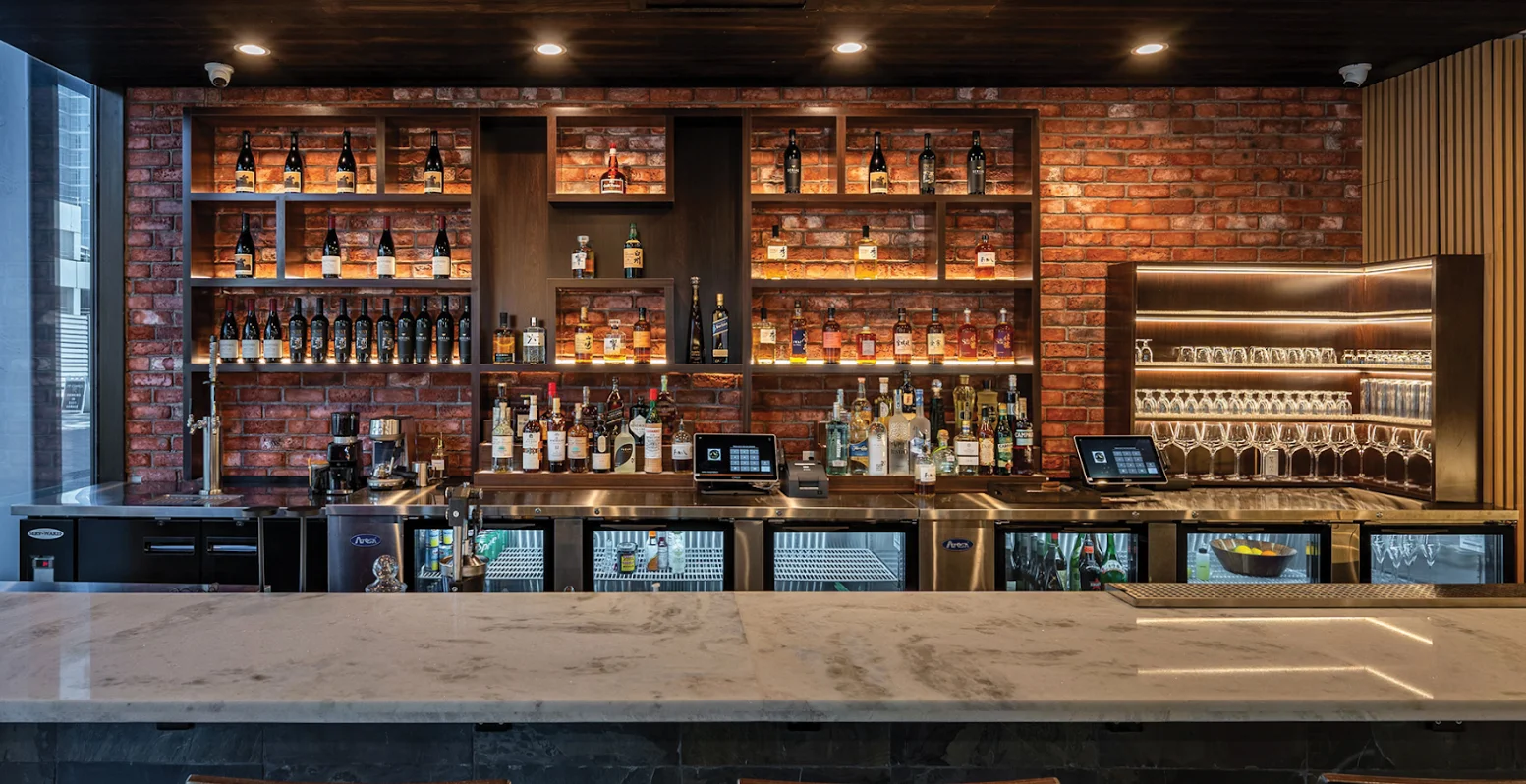 Stylish bar counter with a variety of spirits and modern decor