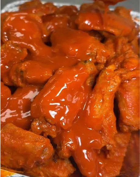 Spicy buffalo chicken wings in a serving tray