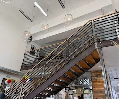 Modern restaurant interior with stylish staircase and pendant lighting