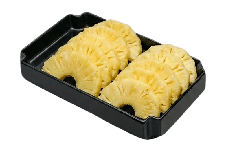 Sliced pineapple rings arranged in a black tray.