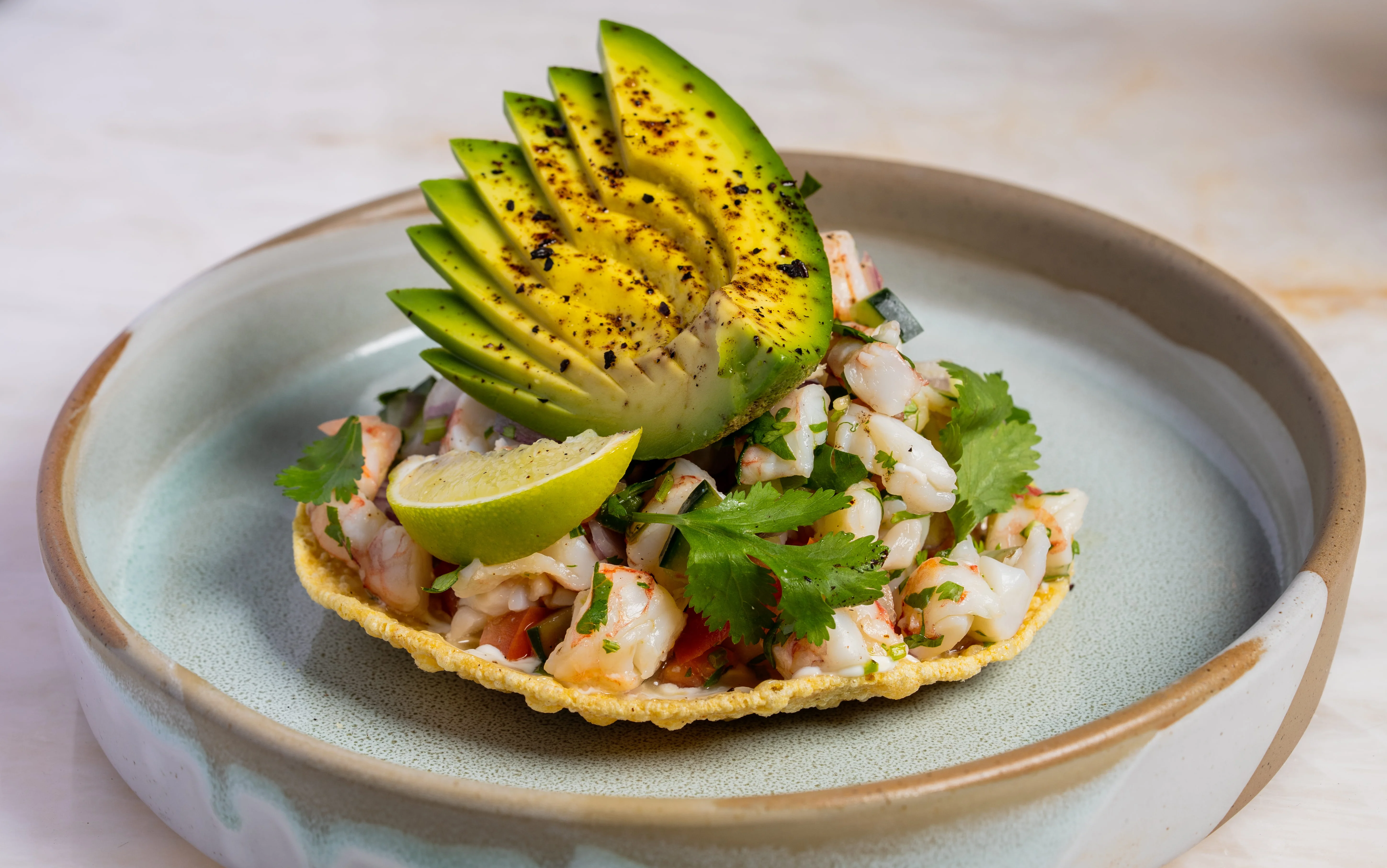 Ceviche tostada with avocado and lime