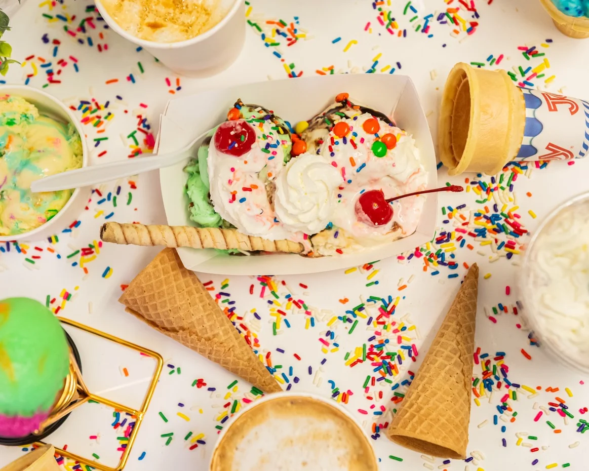 Photo of ice cream cones, sundae, milkshake with sprinkles throughout