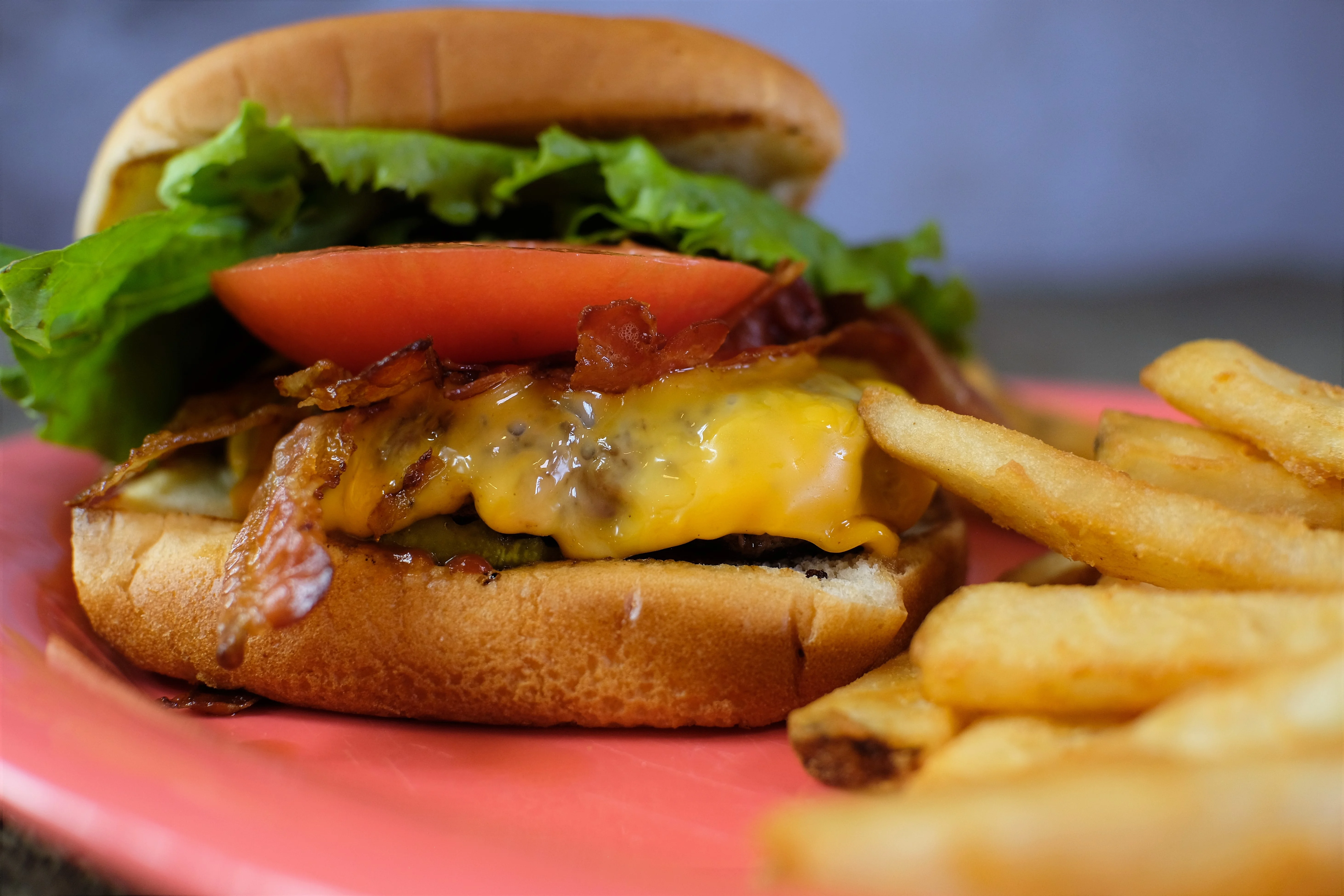 Classic American cheeseburger with bacon and fries