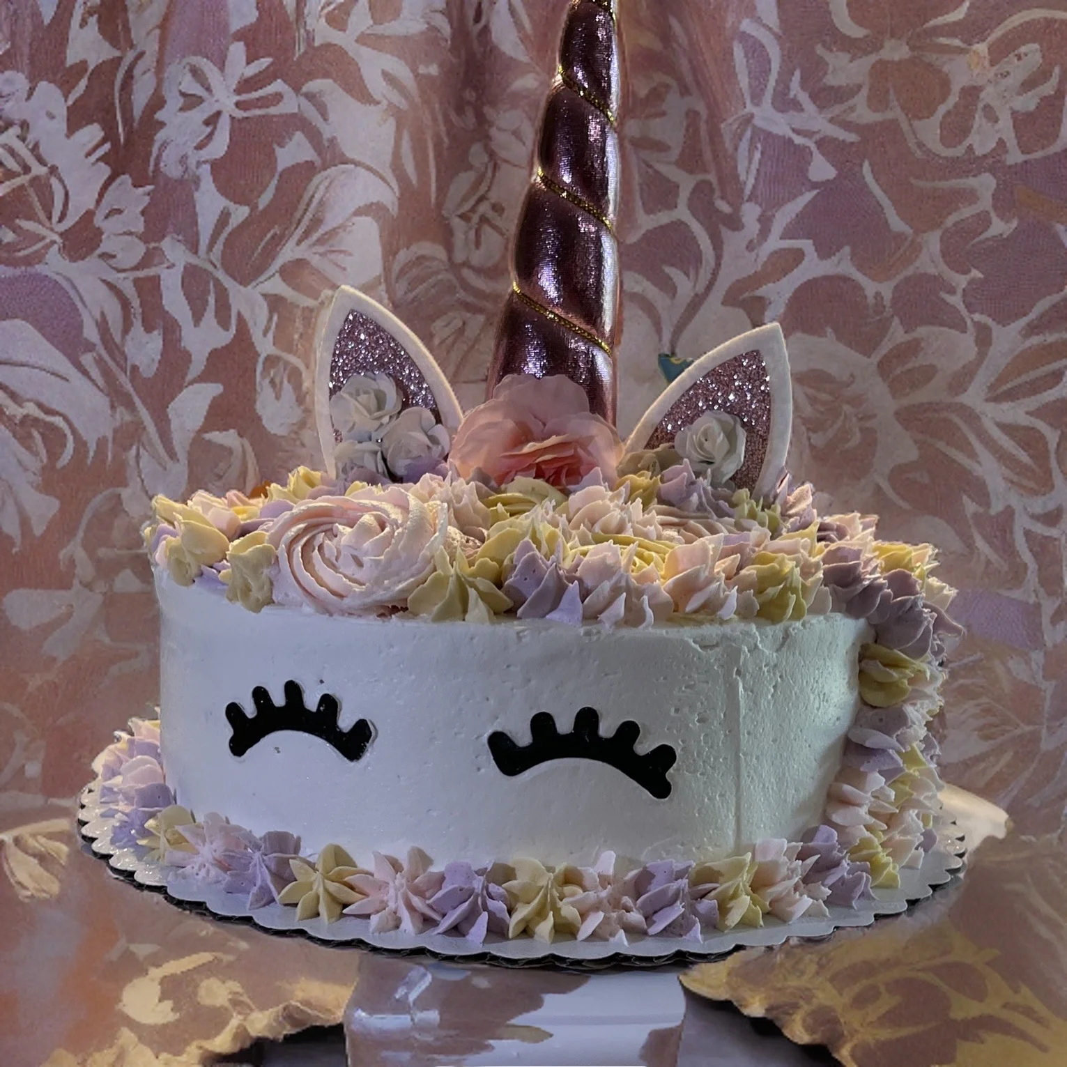 Whimsical unicorn cake with pastel frosting and decorative elements