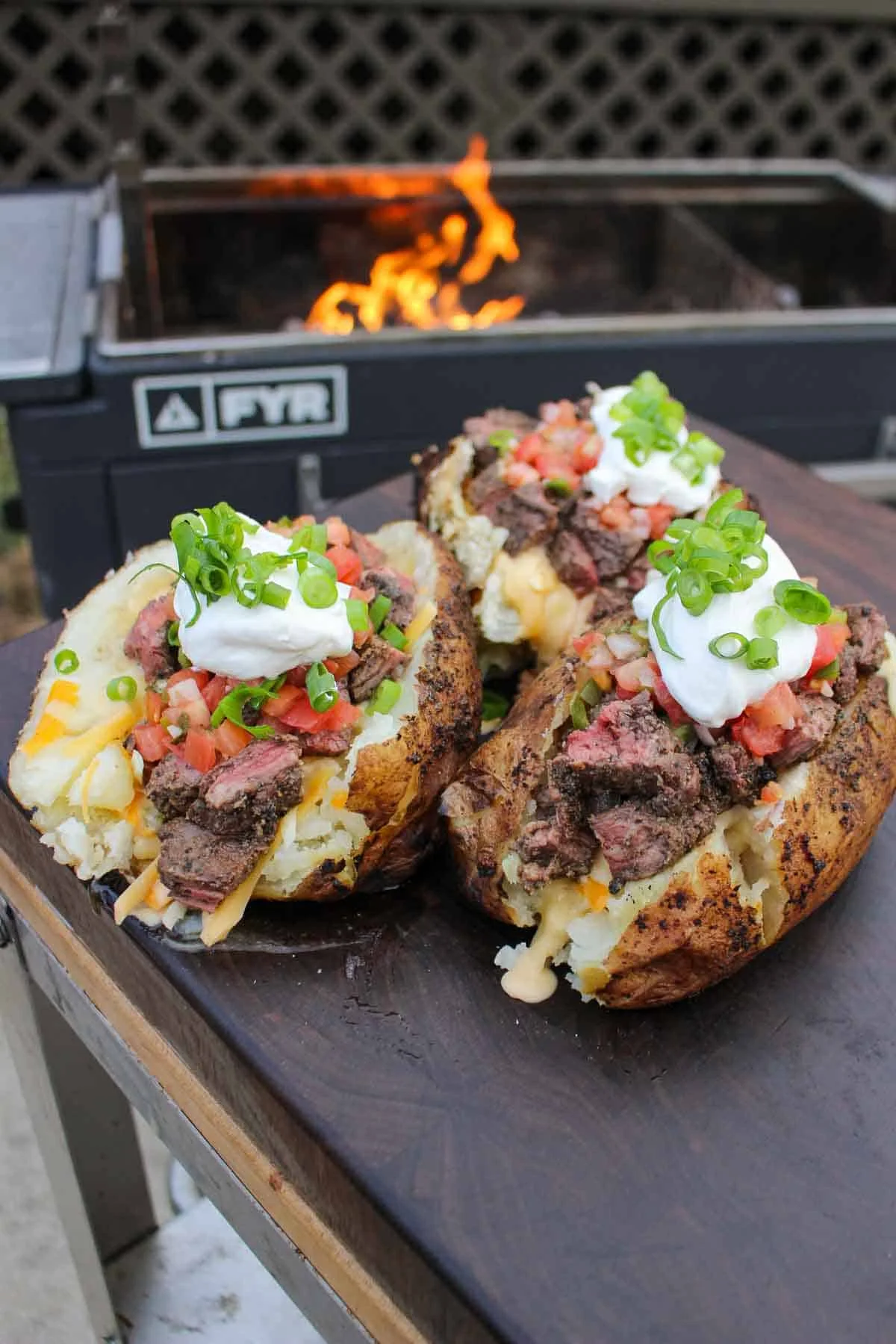 Loaded baked potatoes with steak and toppings