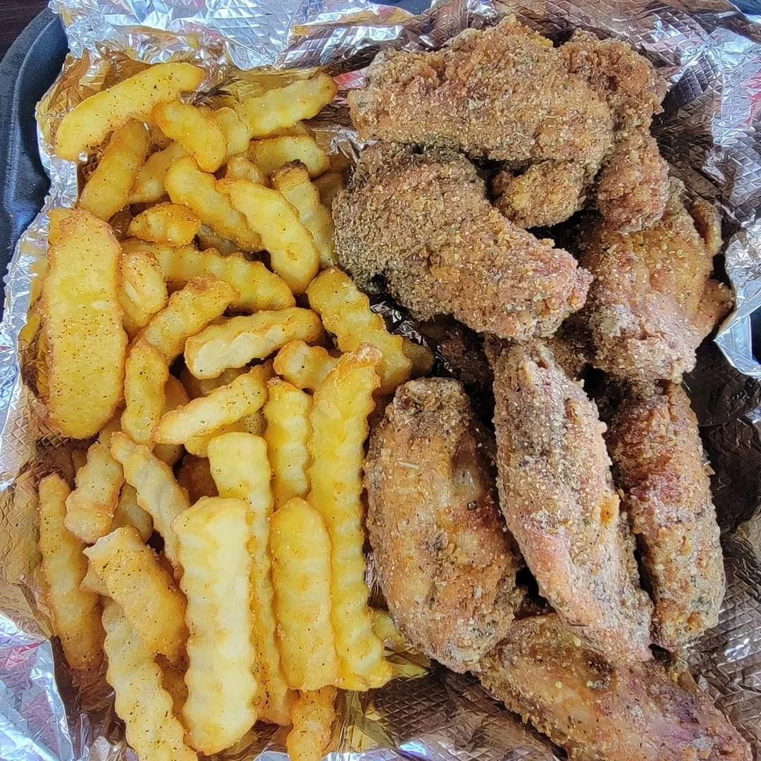 Crispy fried chicken wings with crinkle-cut fries