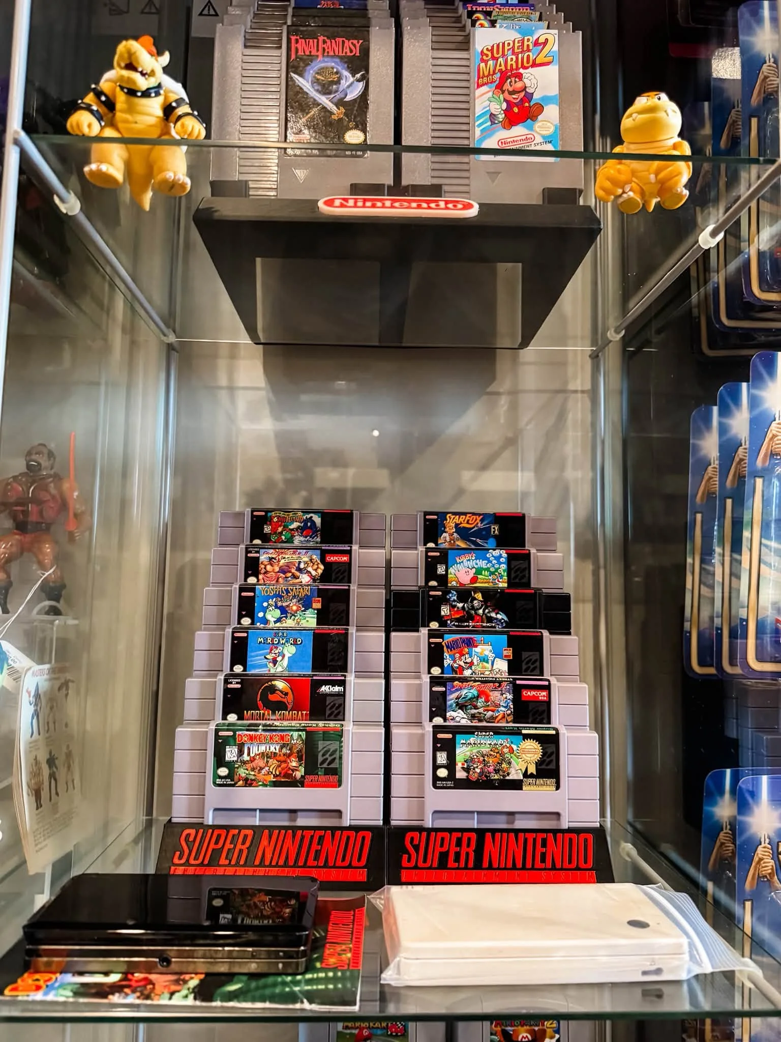 Display of classic Nintendo games and collectibles in a glass cabinet