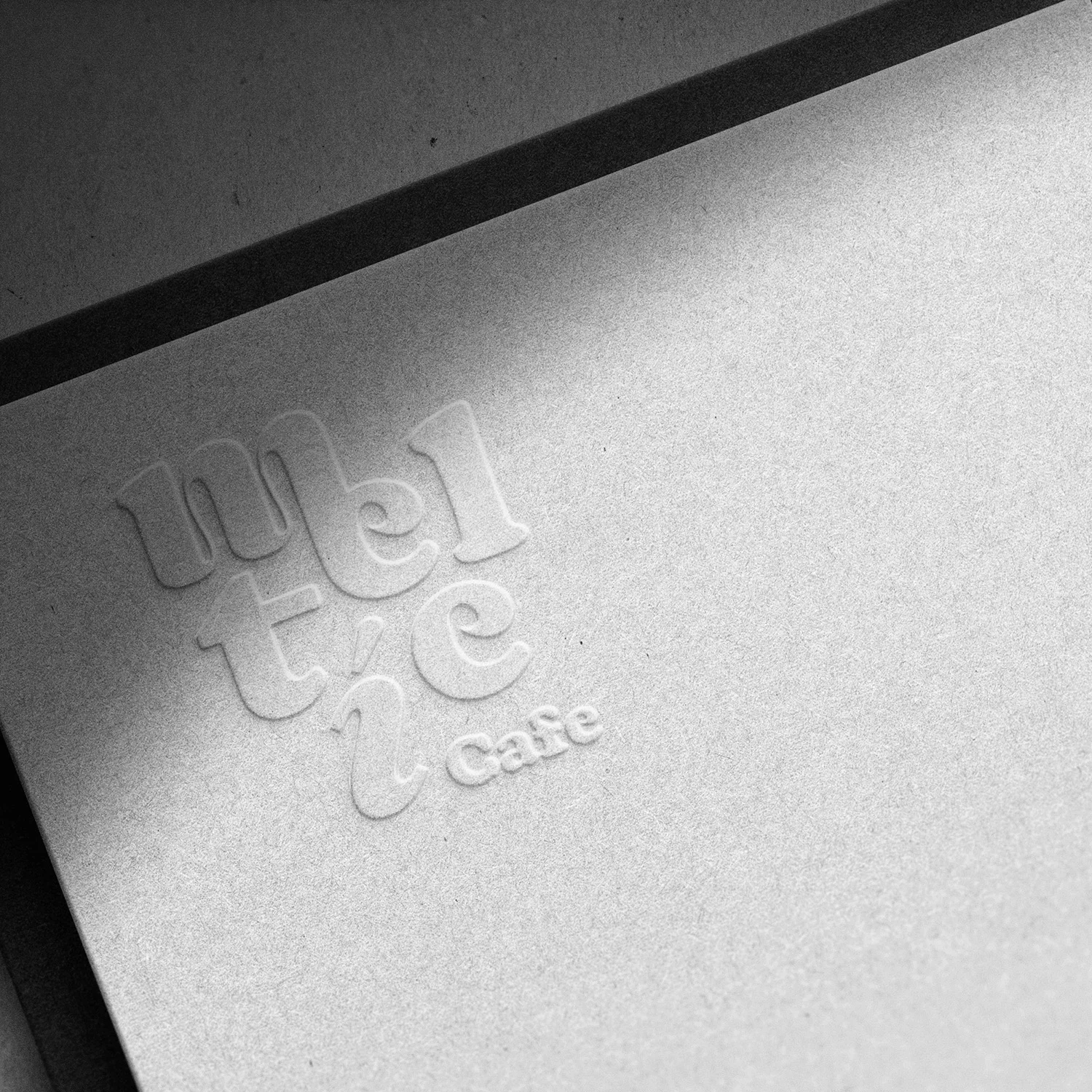 Elegant logo design for Melt Cafe on textured paper background