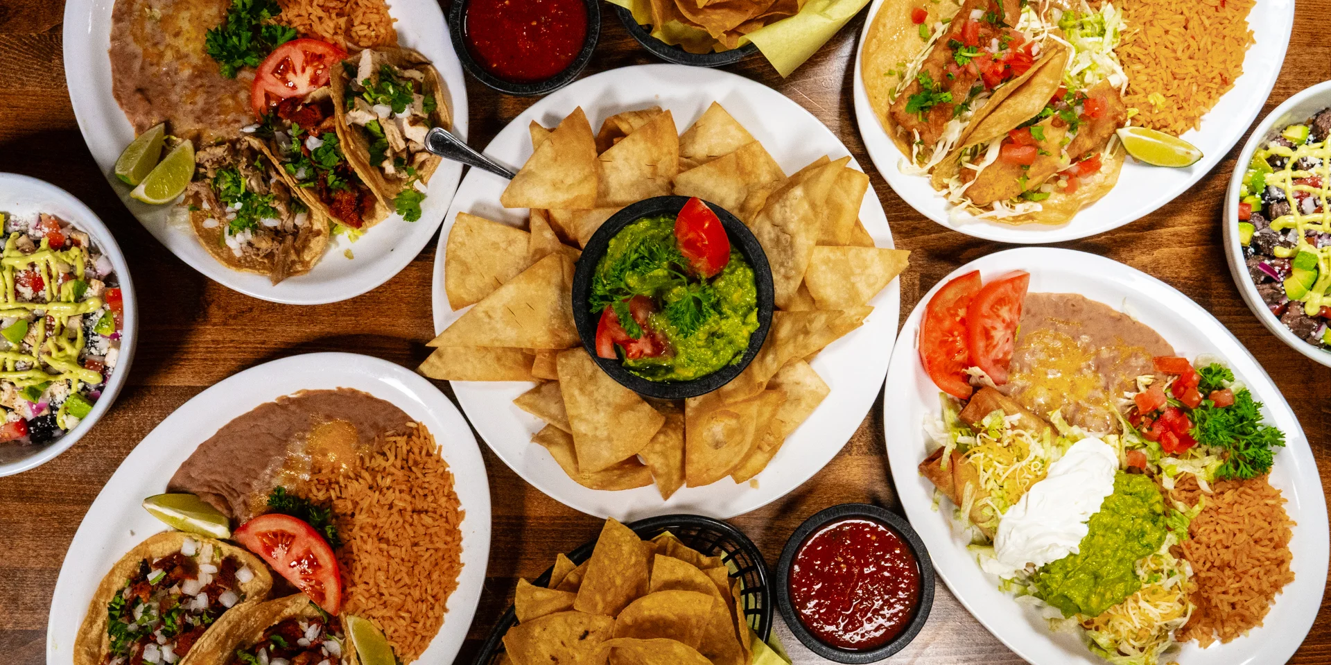Colorful Mexican feast with tacos, guacamole, and rice