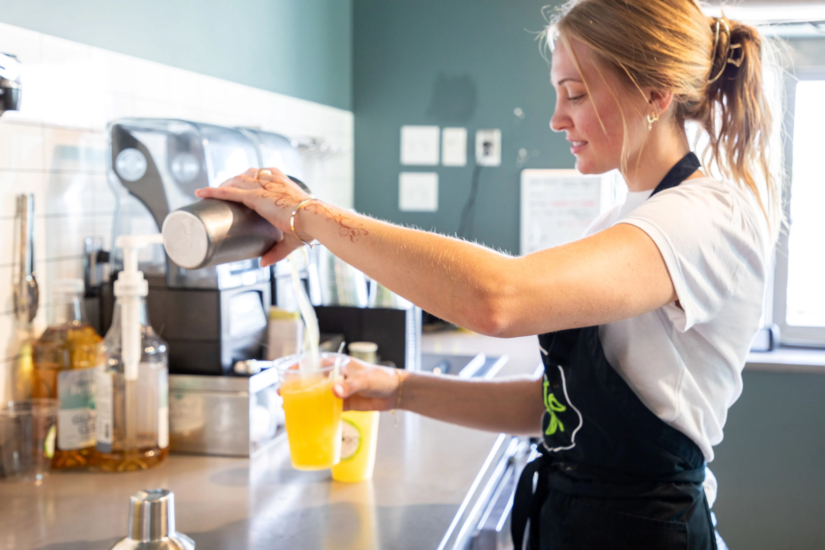 Barista serving refreshing iced tea at a coffee shop