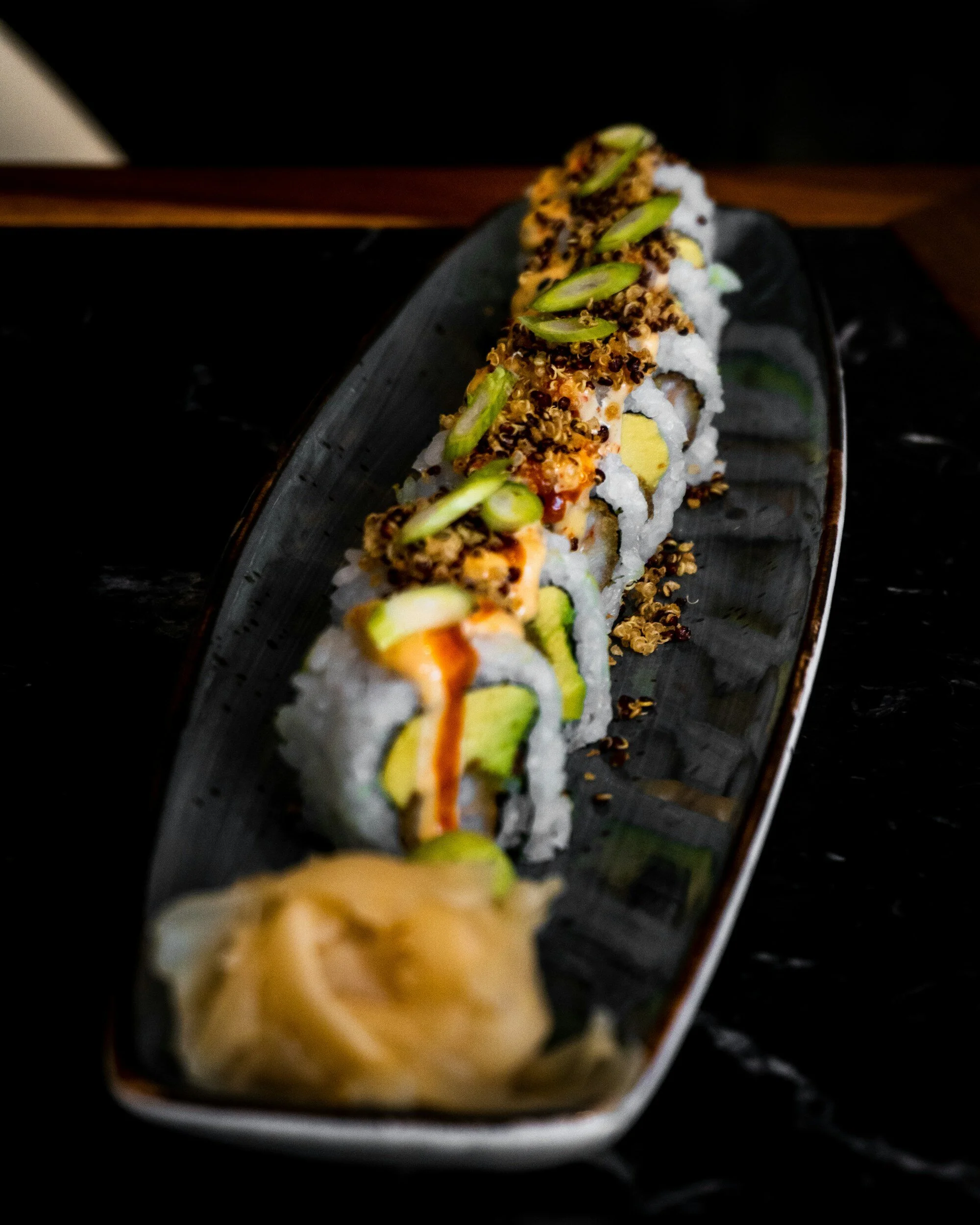 Japanese sushi roll with avocado and spicy sauce