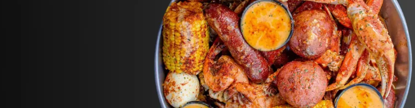 Seafood boil platter with crab, shrimp, and corn