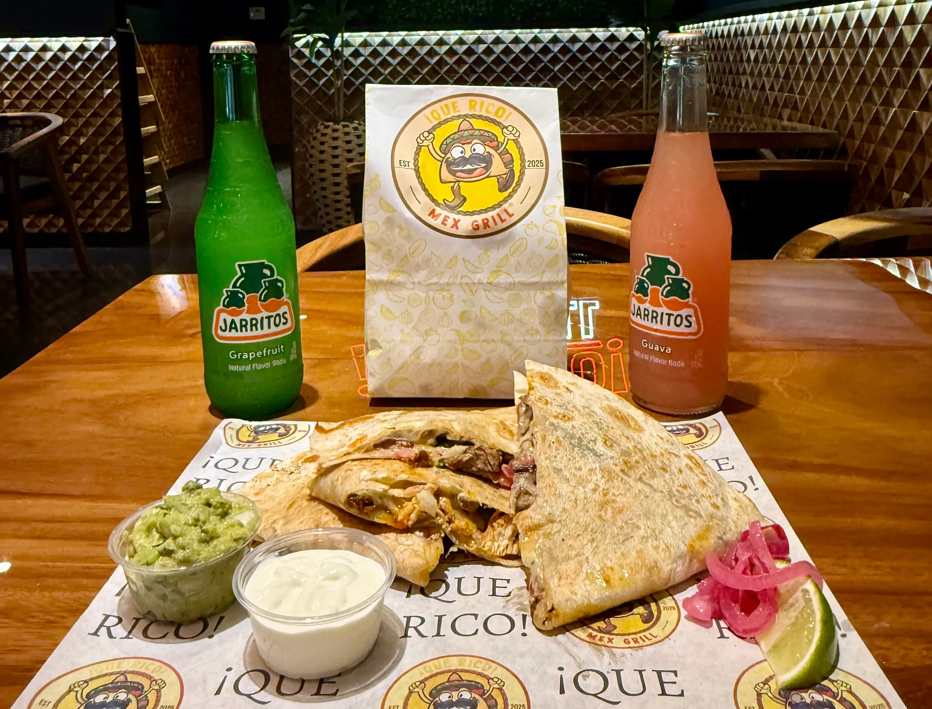 Delicious quesadilla served with guacamole and drinks in a vibrant restaurant
