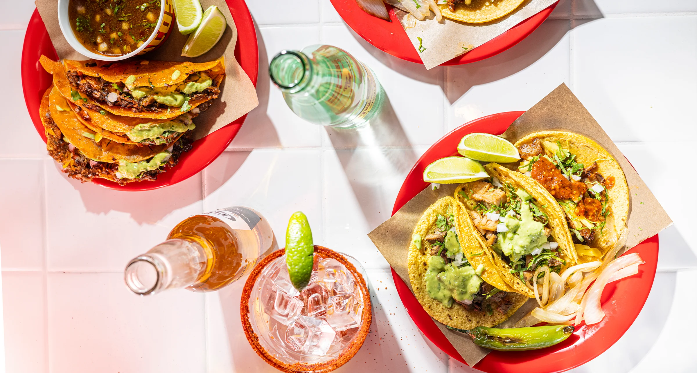 Authentic Mexican tacos with guacamole and lime wedges