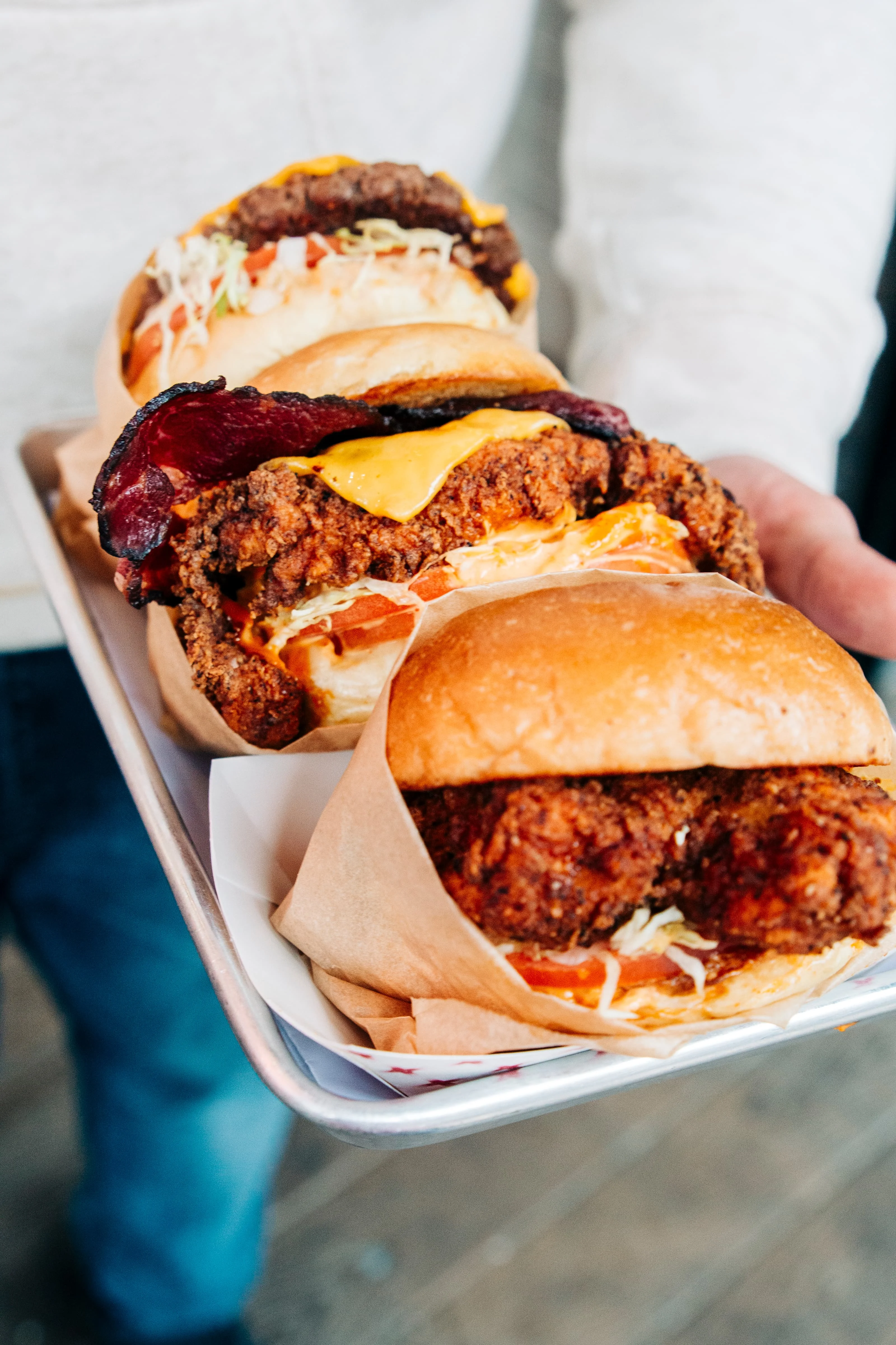 Delicious burger with toppings served on a wooden table