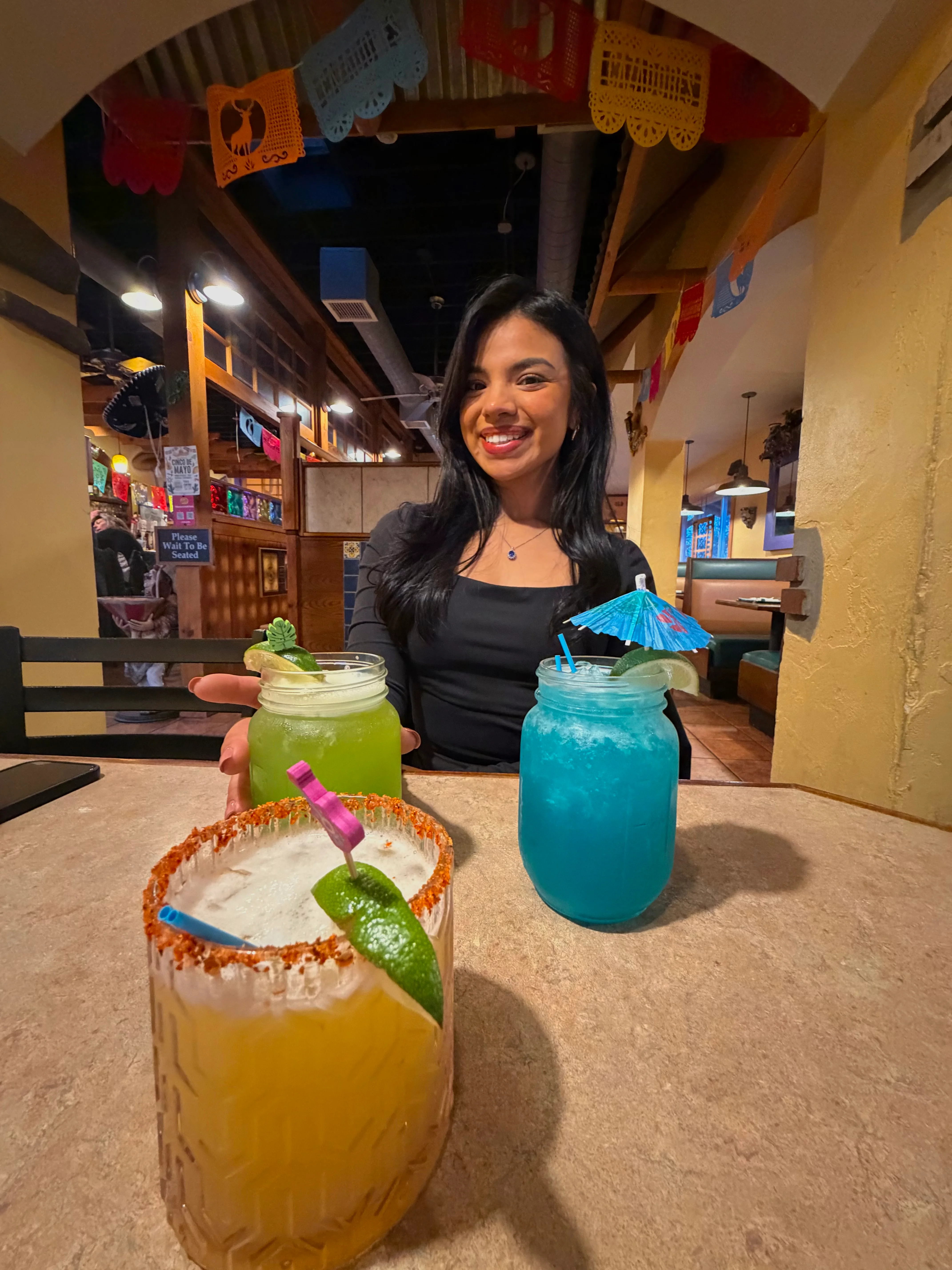 Colorful cocktails on a table in a vibrant restaurant setting