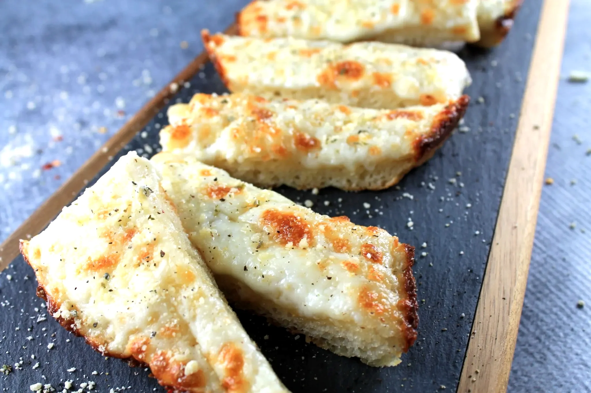 Delicious cinnamon bites drizzled with icing on a white plate.