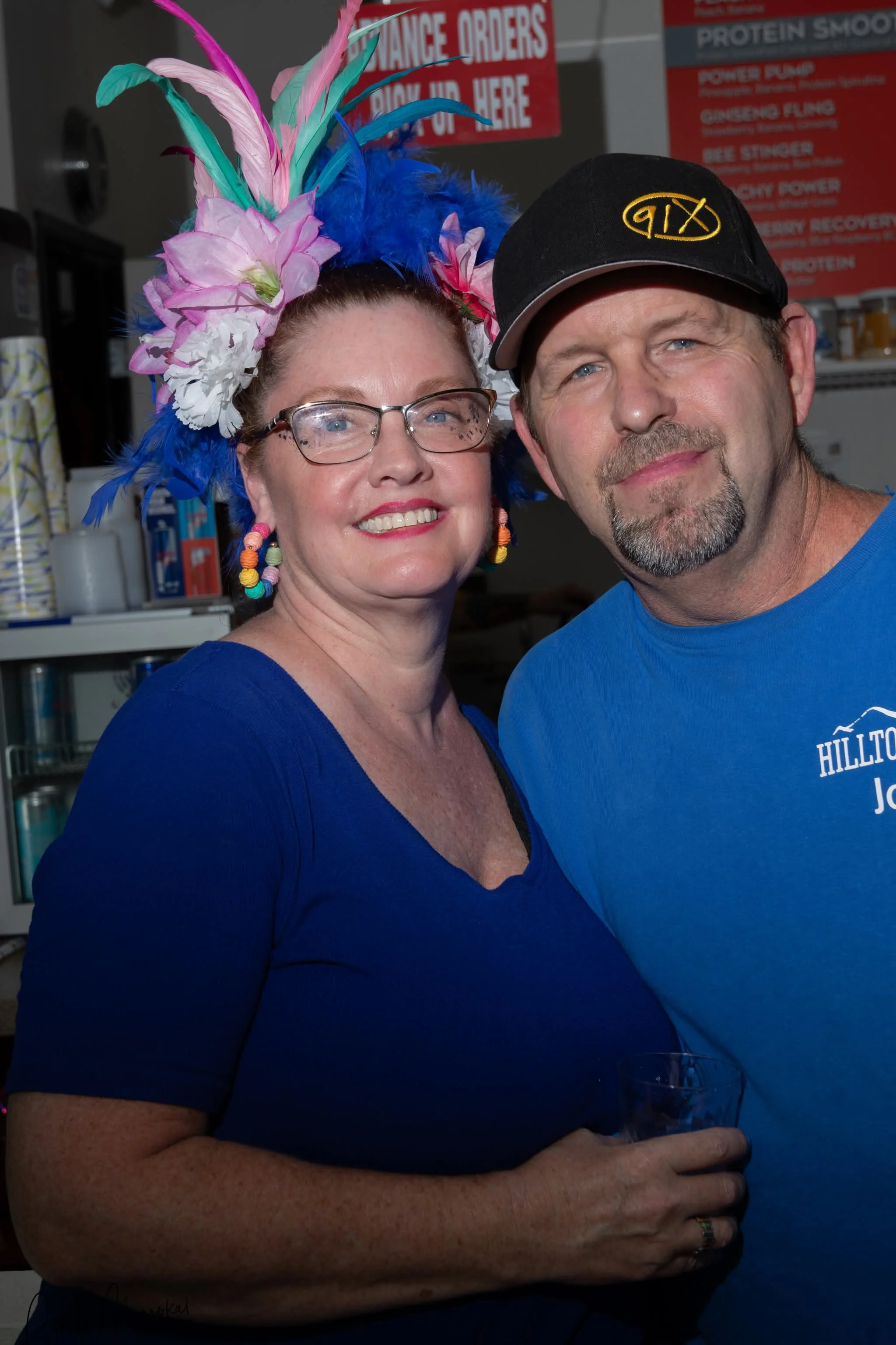 Friendly deli owners posing in their restaurant