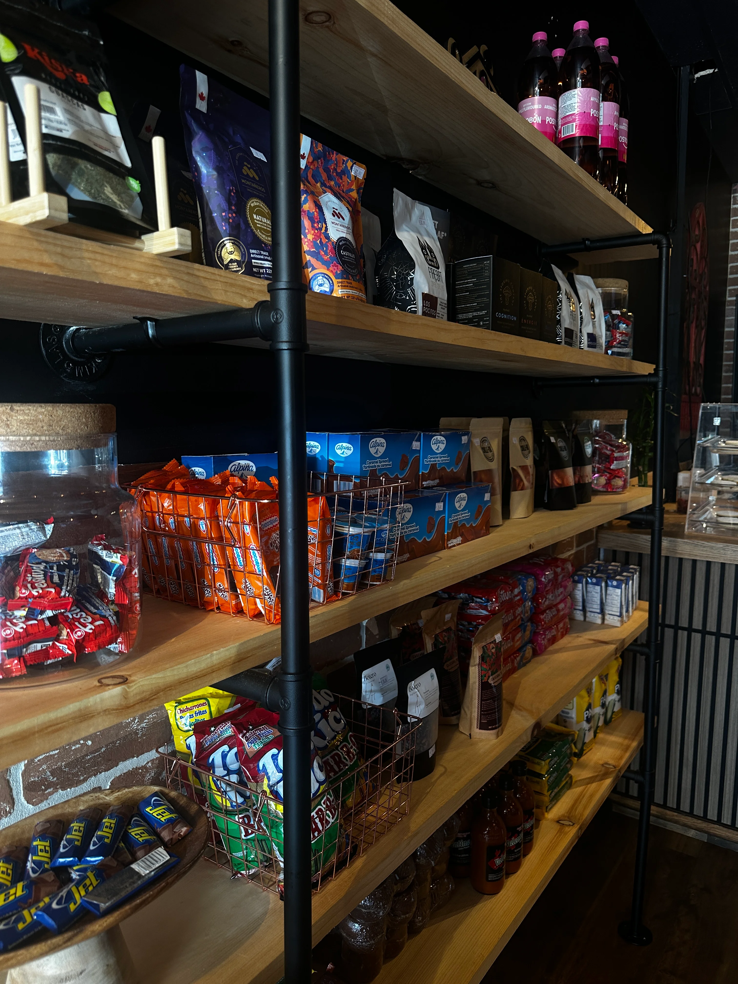 Well-stocked shelves of snacks and beverages in a cozy store interior