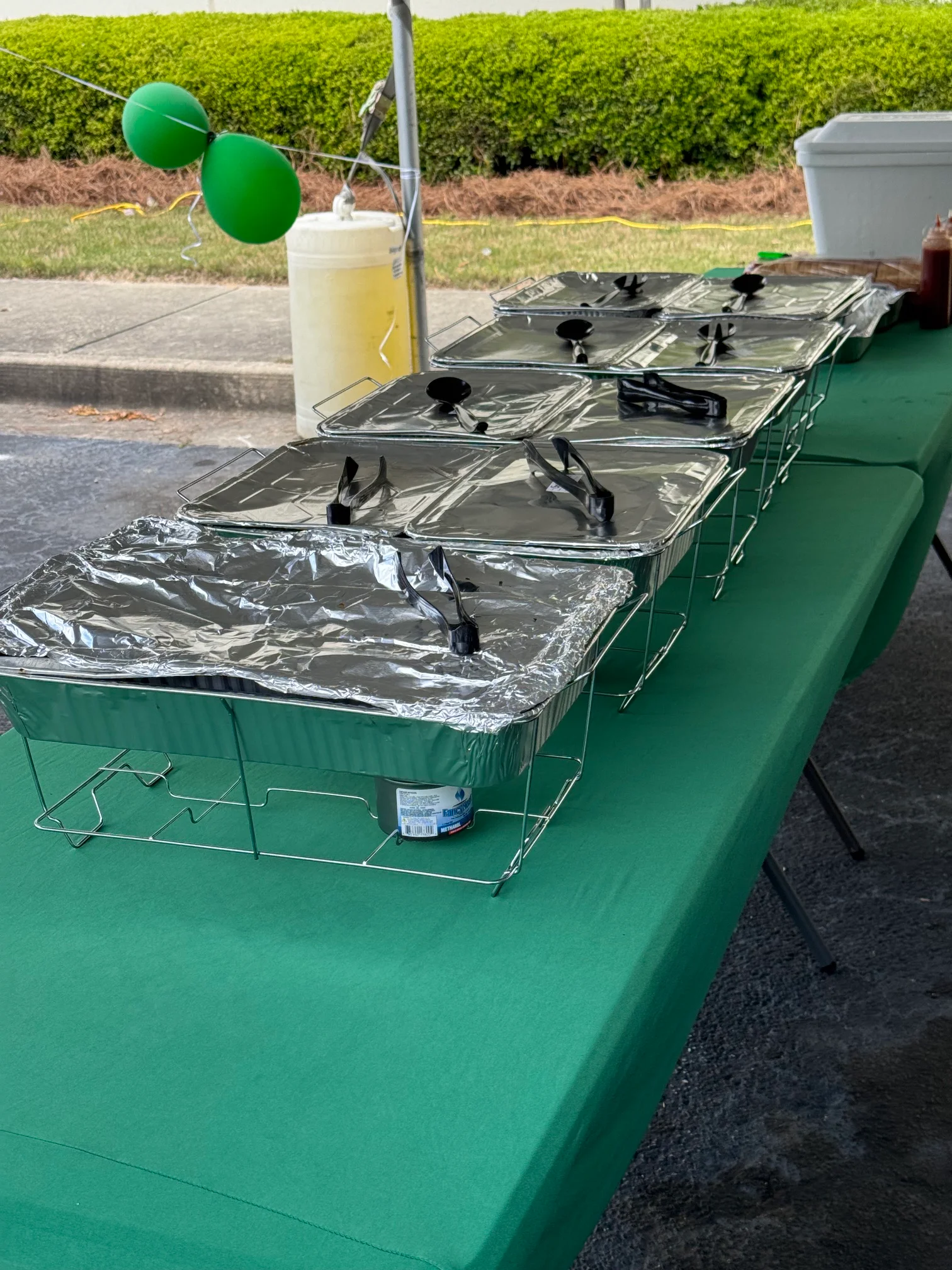 Catering setup with chafing dishes under a tent