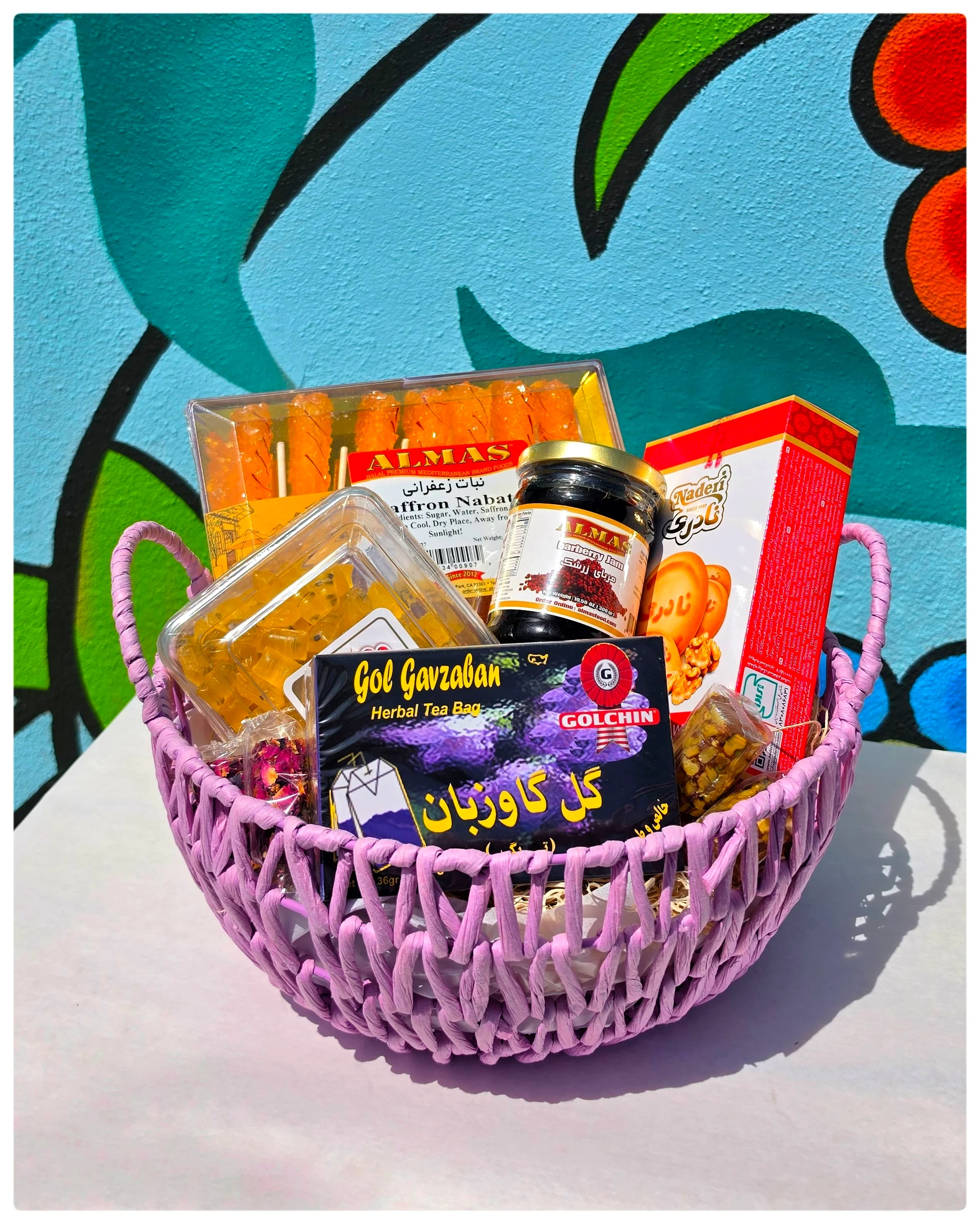 Colorful Persian sweets and herbal tea in a decorative basket