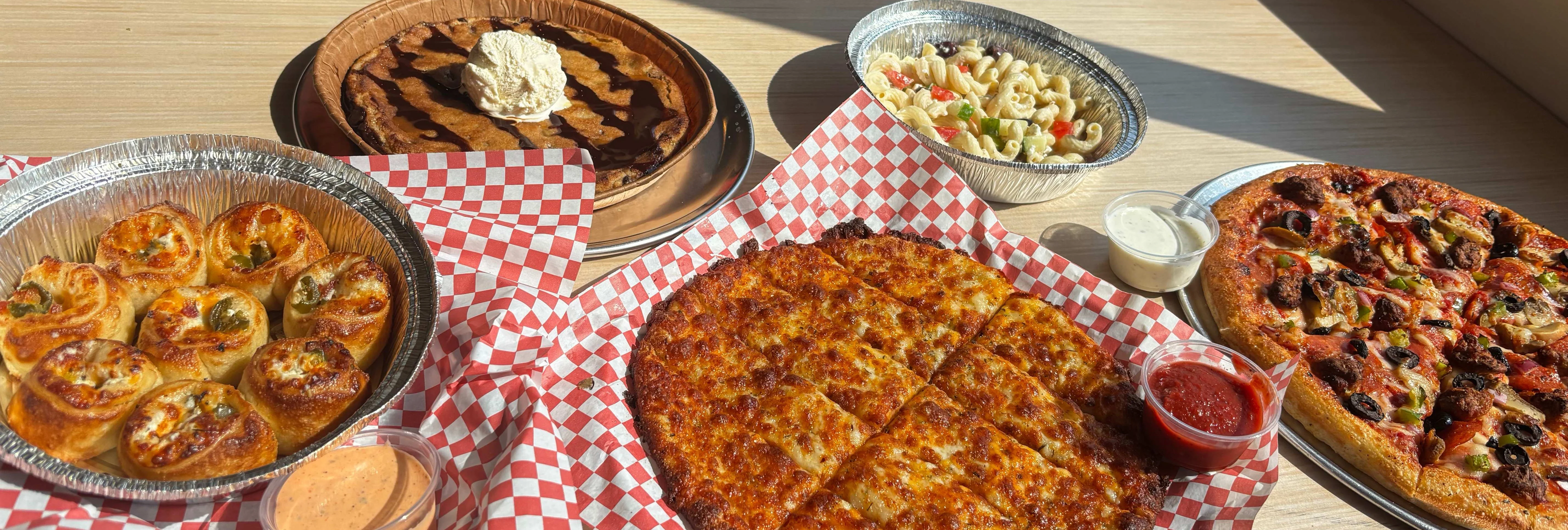 Assorted pizzas and pasta in a casual dining setting