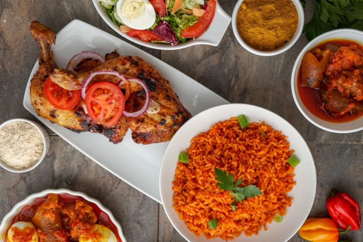 Nigerian jollof rice with grilled chicken and assorted sides