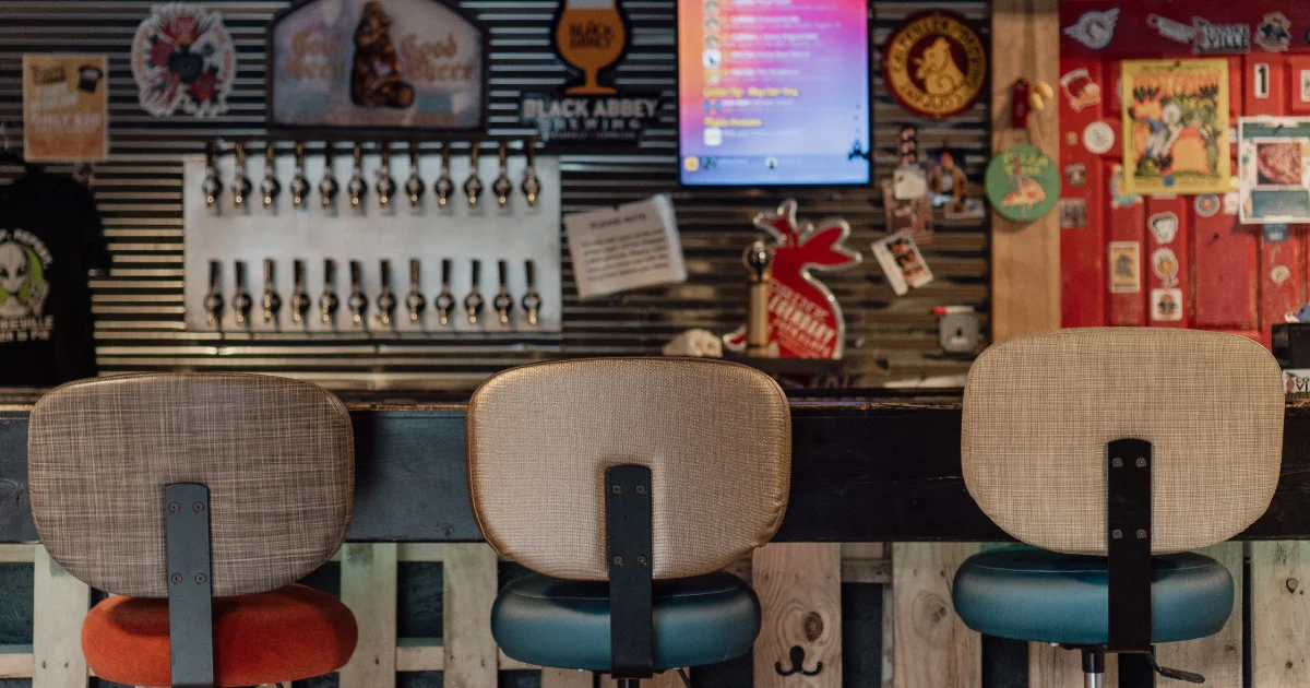 Stylish bar interior with colorful decor and seating at a modern pub