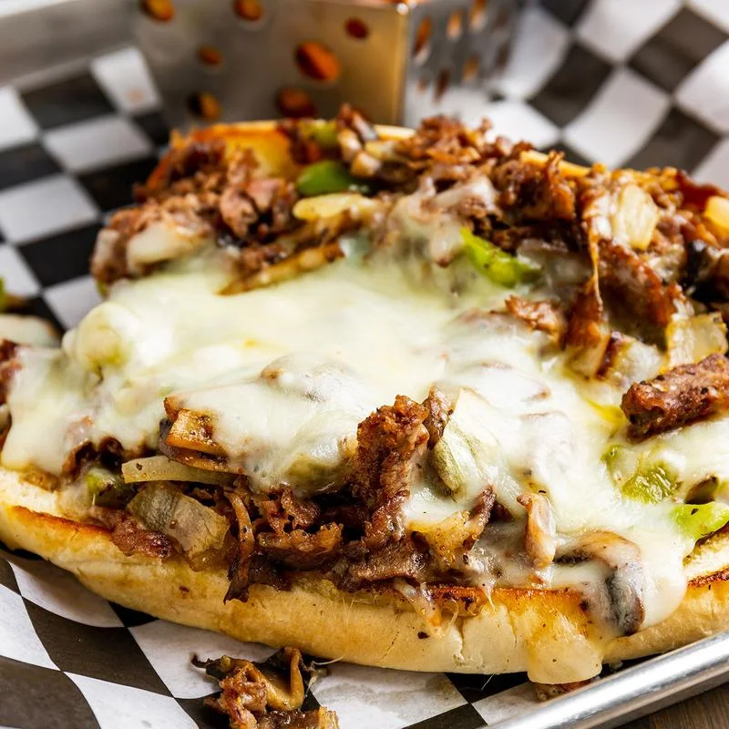 Cheesesteak sandwich with melted cheese and grilled onions