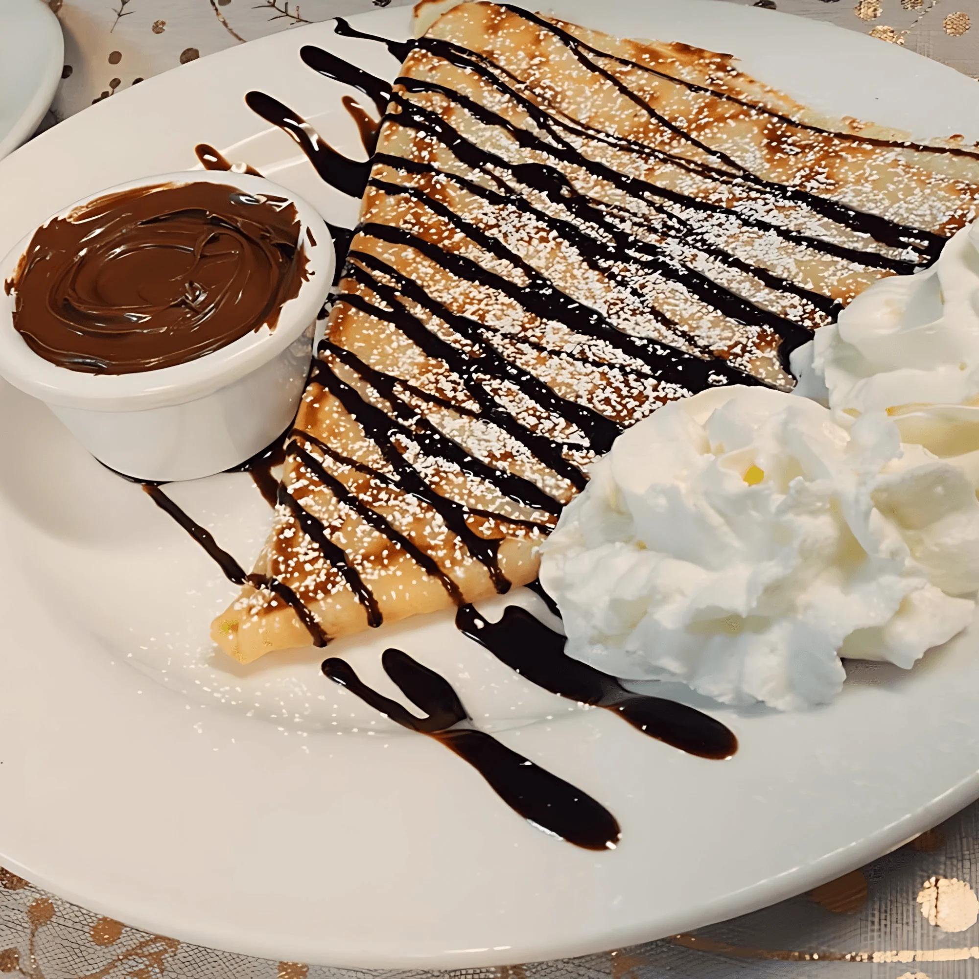 Delicious French crepe drizzled with chocolate sauce and whipped cream