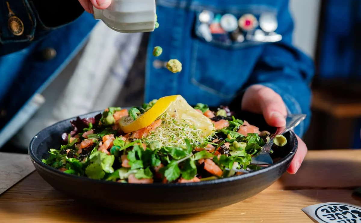 Fresh garden salad with lemon and herbs in a rustic bowl