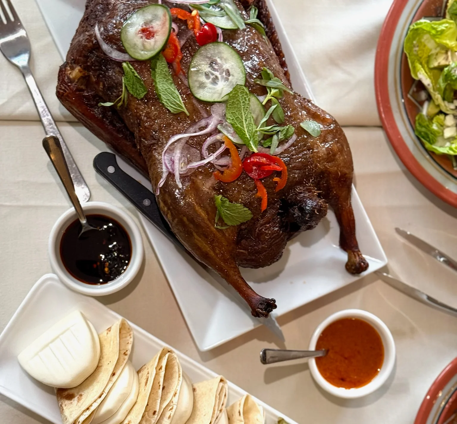 Whole roasted duck served with tortillas and grilled vegetables