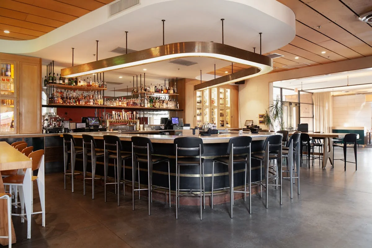 Modern bar interior with stylish seating and a wide selection of spirits