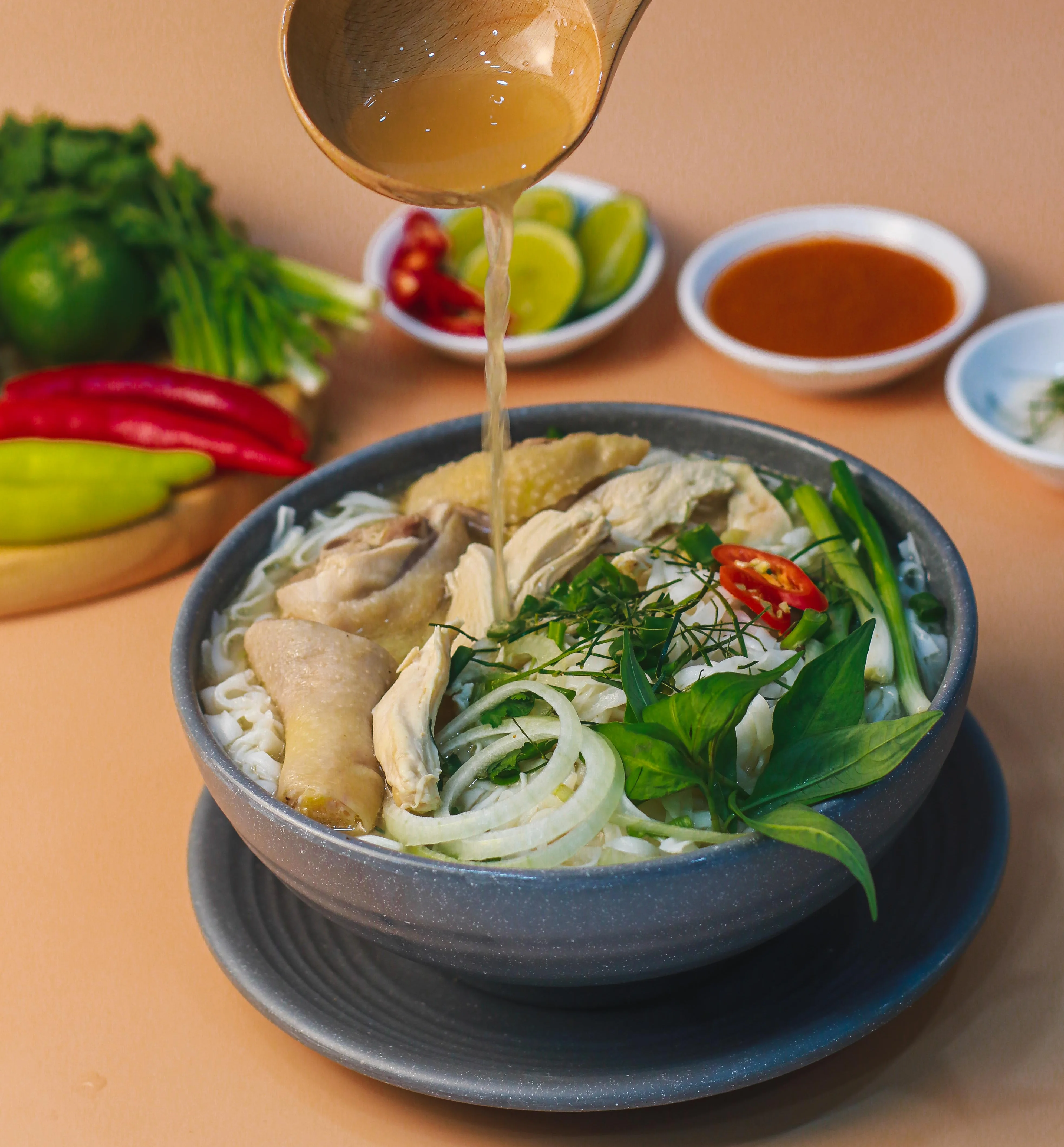 Bowl of Vietnamese chicken pho with fresh herbs and broth