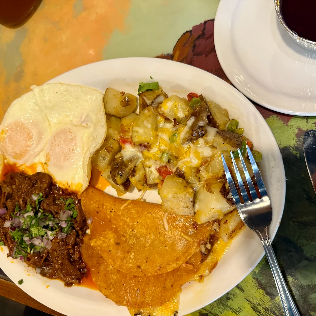 Traditional Mexican breakfast plate with eggs, beef, and potatoes