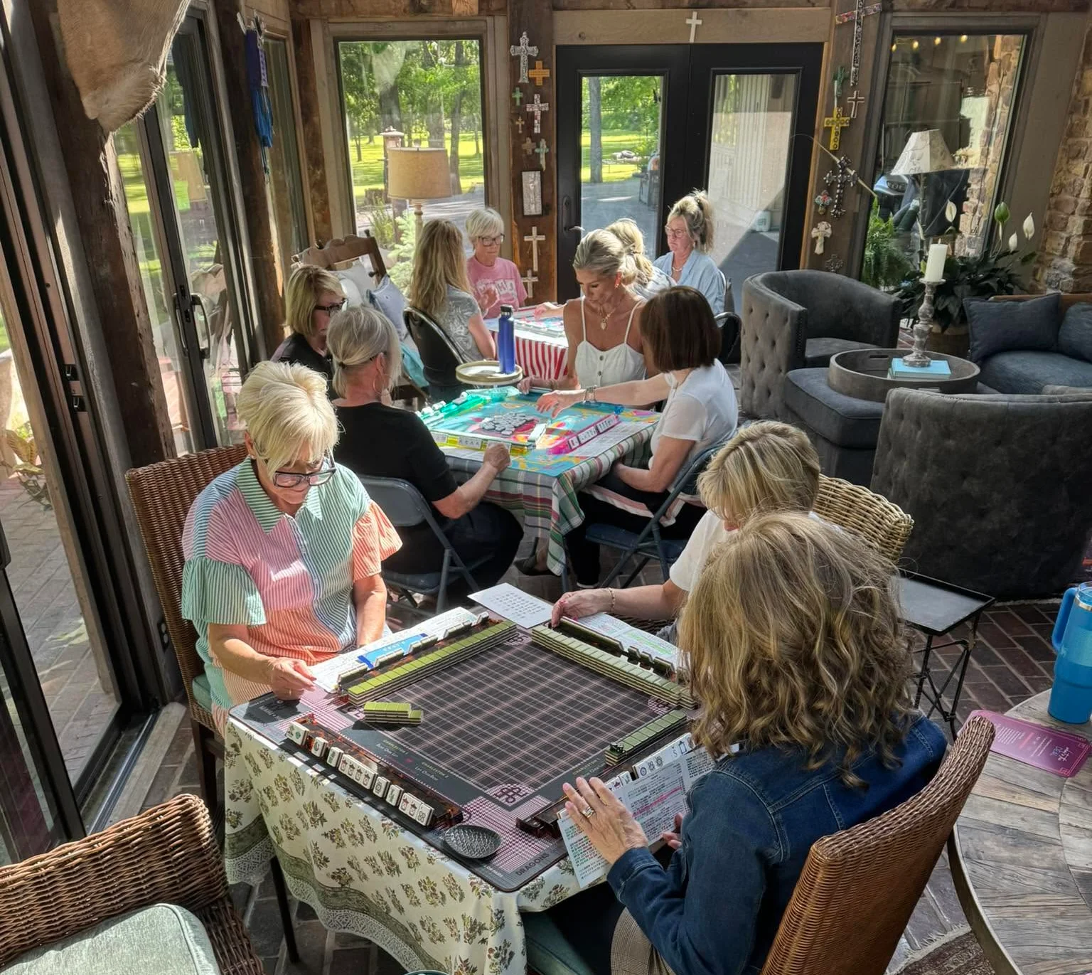Group of friends enjoying a game of mahjong in a cozy sunroom