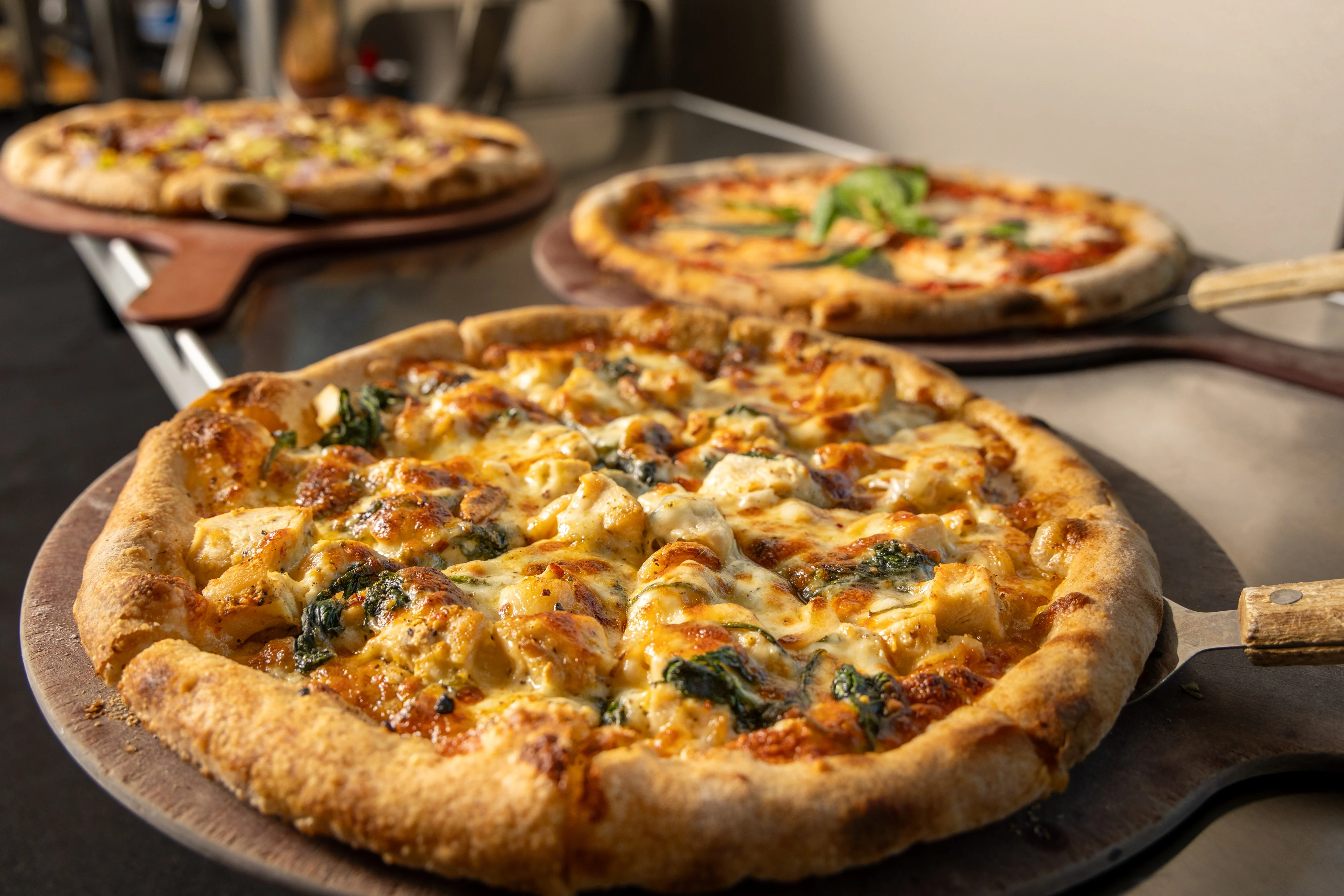 Delicious wood-fired chicken pizza with spinach