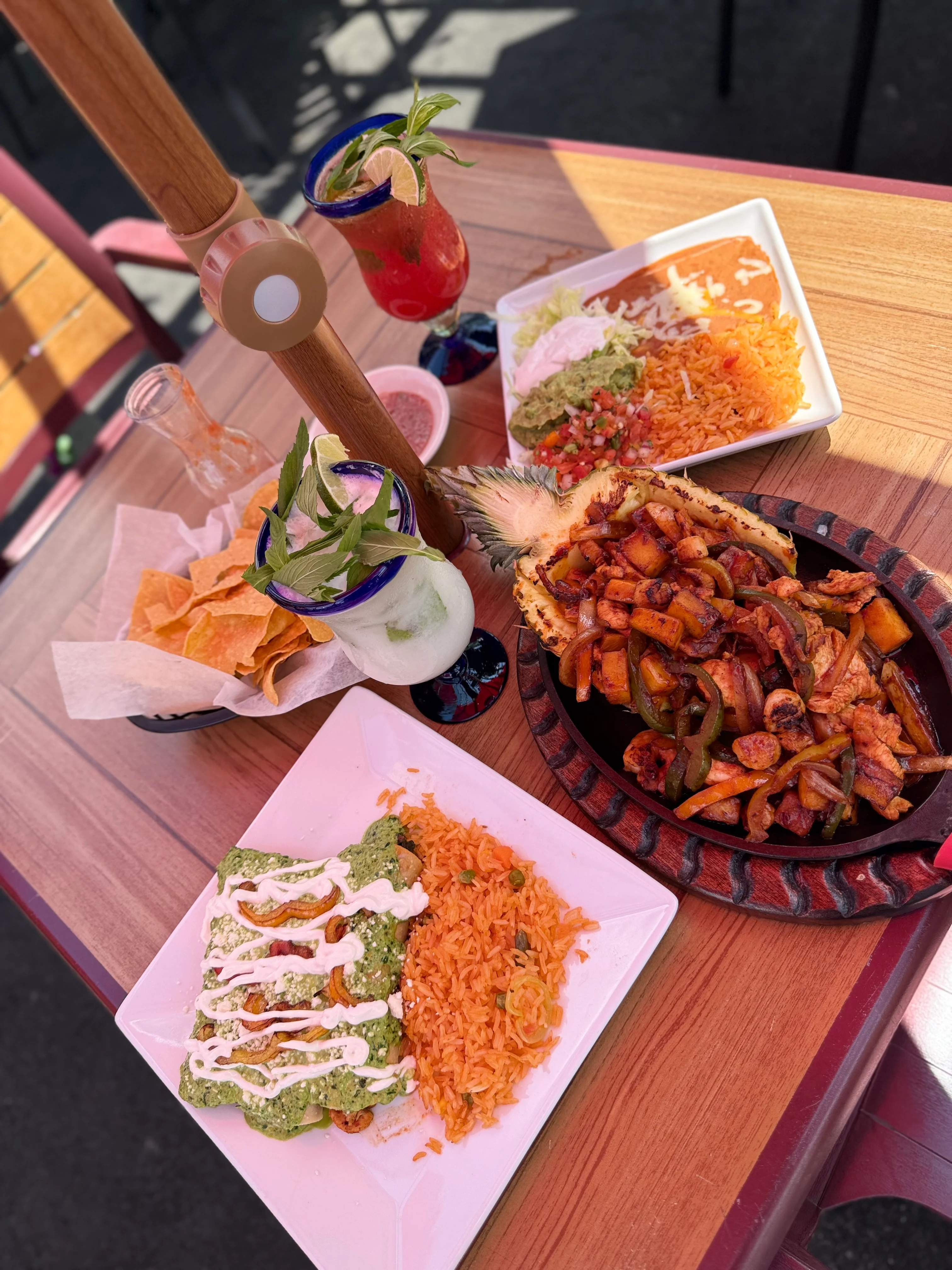 Colorful Mexican feast with fajitas, enchiladas, and refreshing cocktails