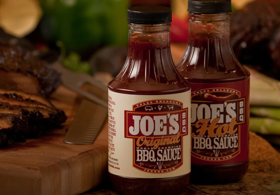 Bottles of BBQ sauce on a wooden cutting board