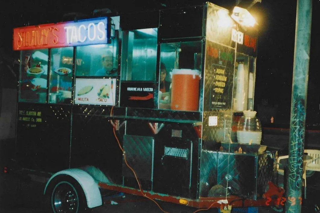 Colorful taco truck serving authentic Mexican street tacos
