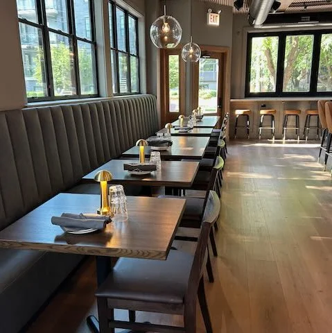 Modern restaurant interior with cozy seating and natural light