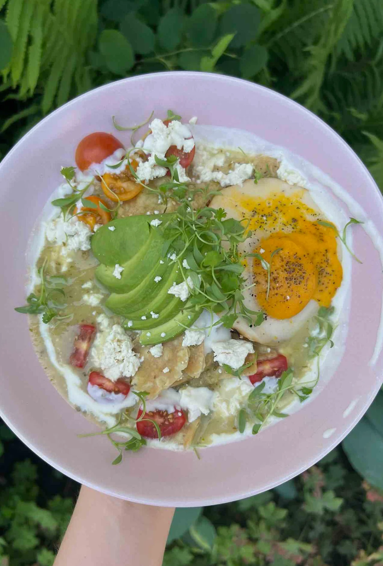 Colorful Mexican huevos rancheros with avocado and fresh toppings