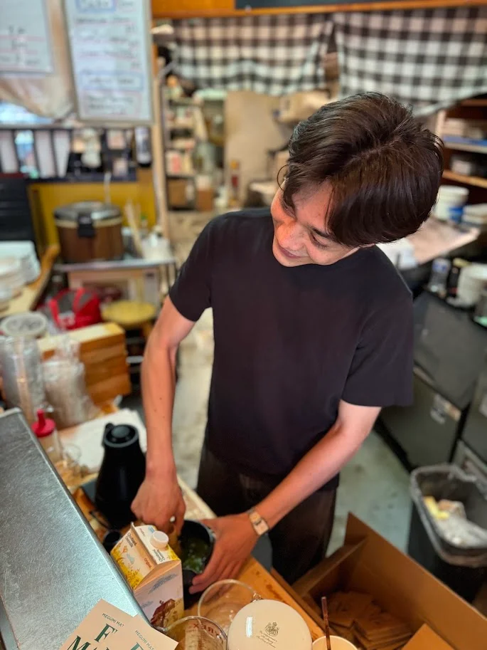 Barista preparing matcha in a cozy café