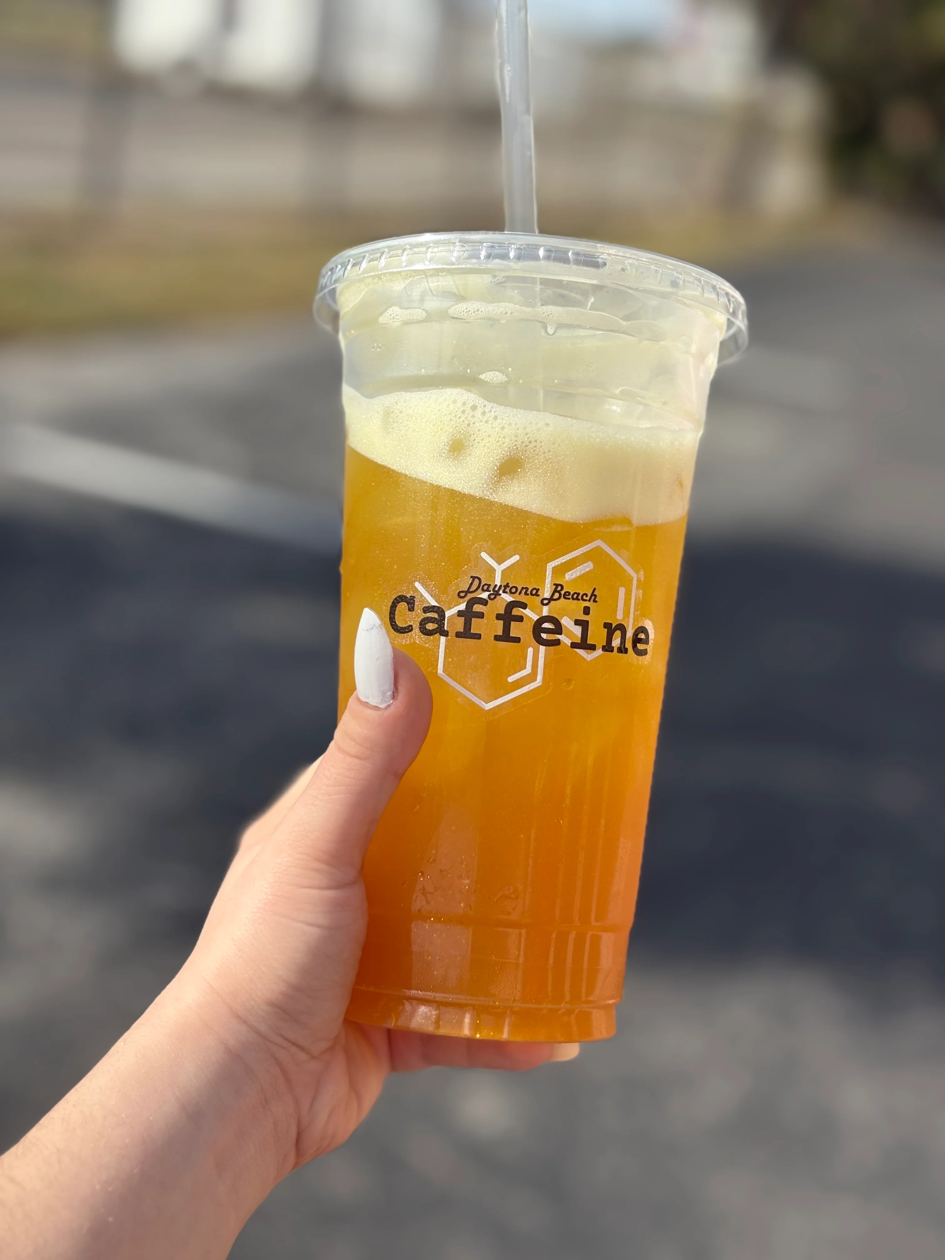 Refreshing iced tea in a clear cup from Daytona Beach Caffeine
