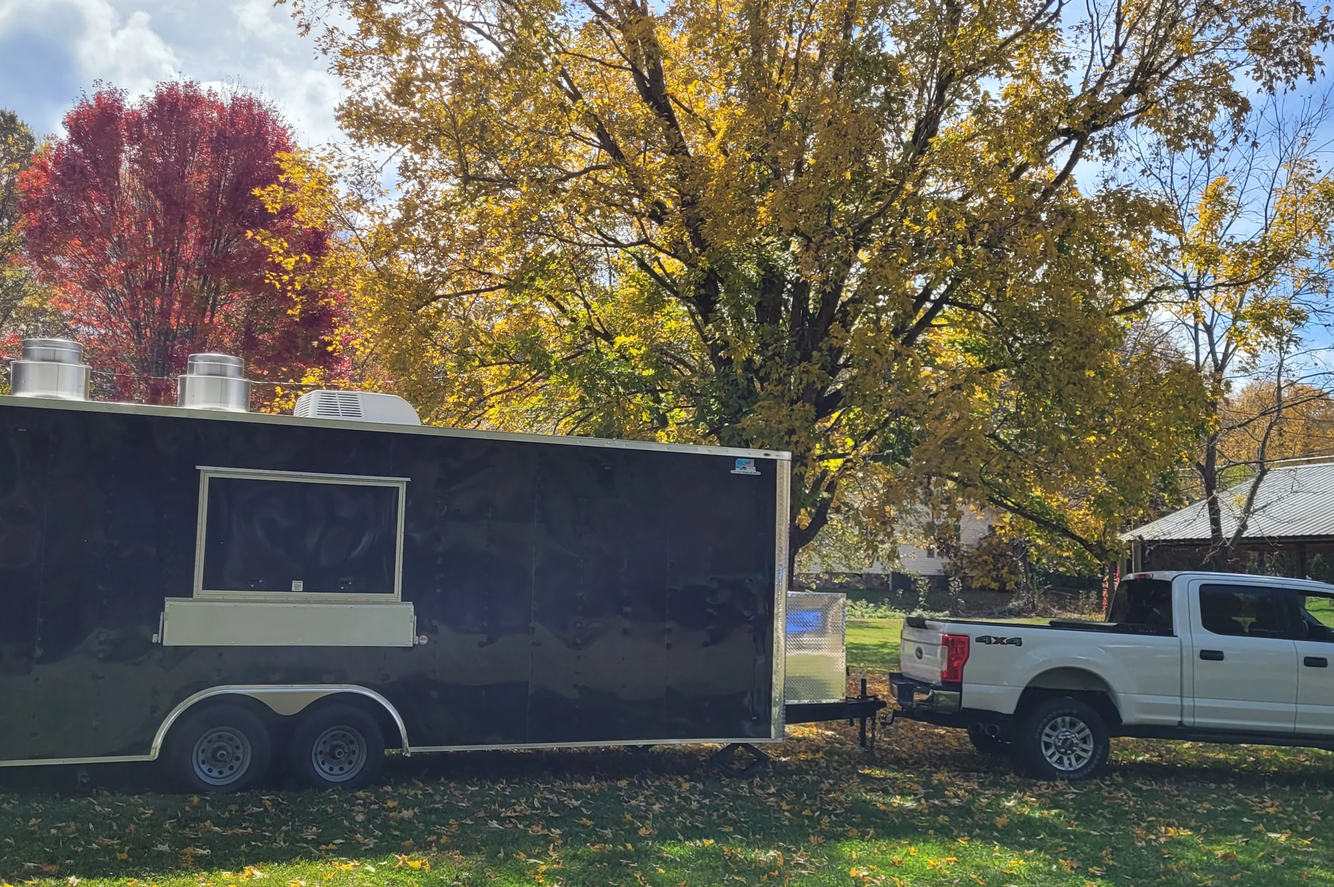 Food truck parked in a scenic autumn setting