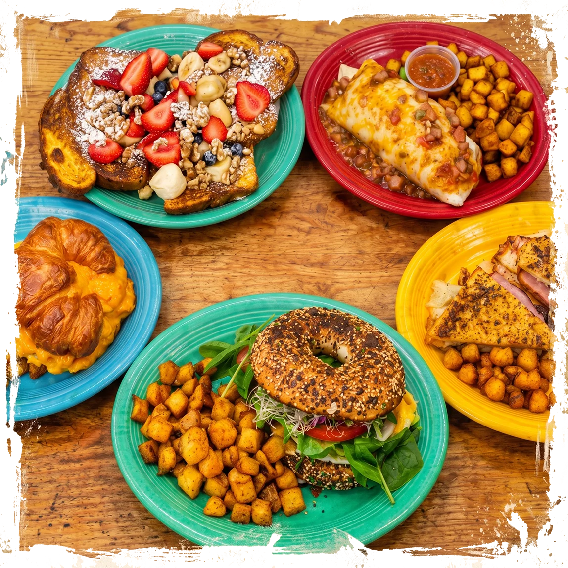 Colorful brunch spread with French toast, breakfast burrito, bagel sandwich, and croissant sandwich