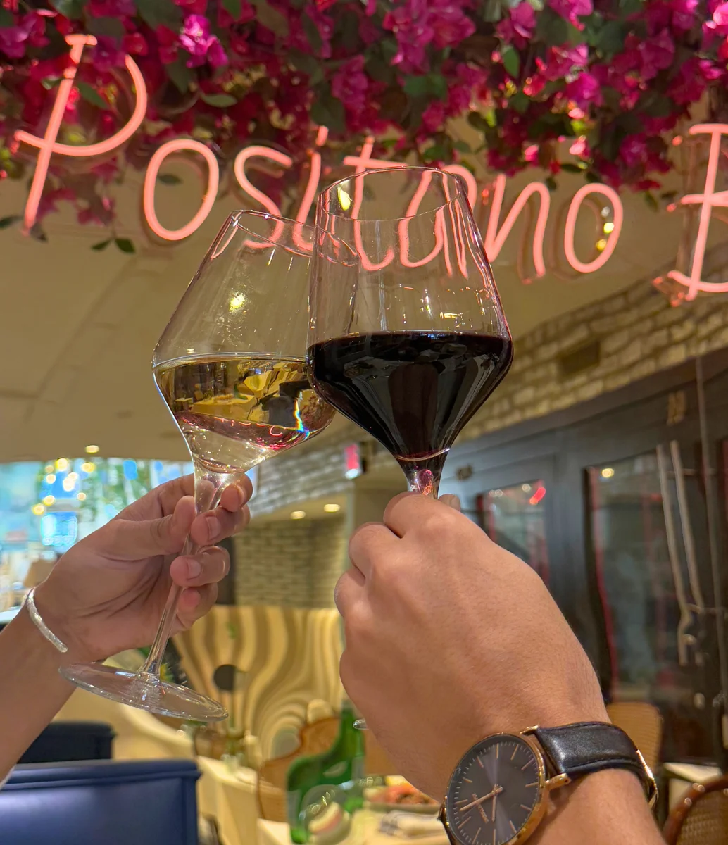 Cheers with wine glasses in a vibrant restaurant setting