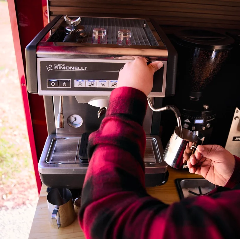 Image of a barista purging the steam wand of an espresso maching