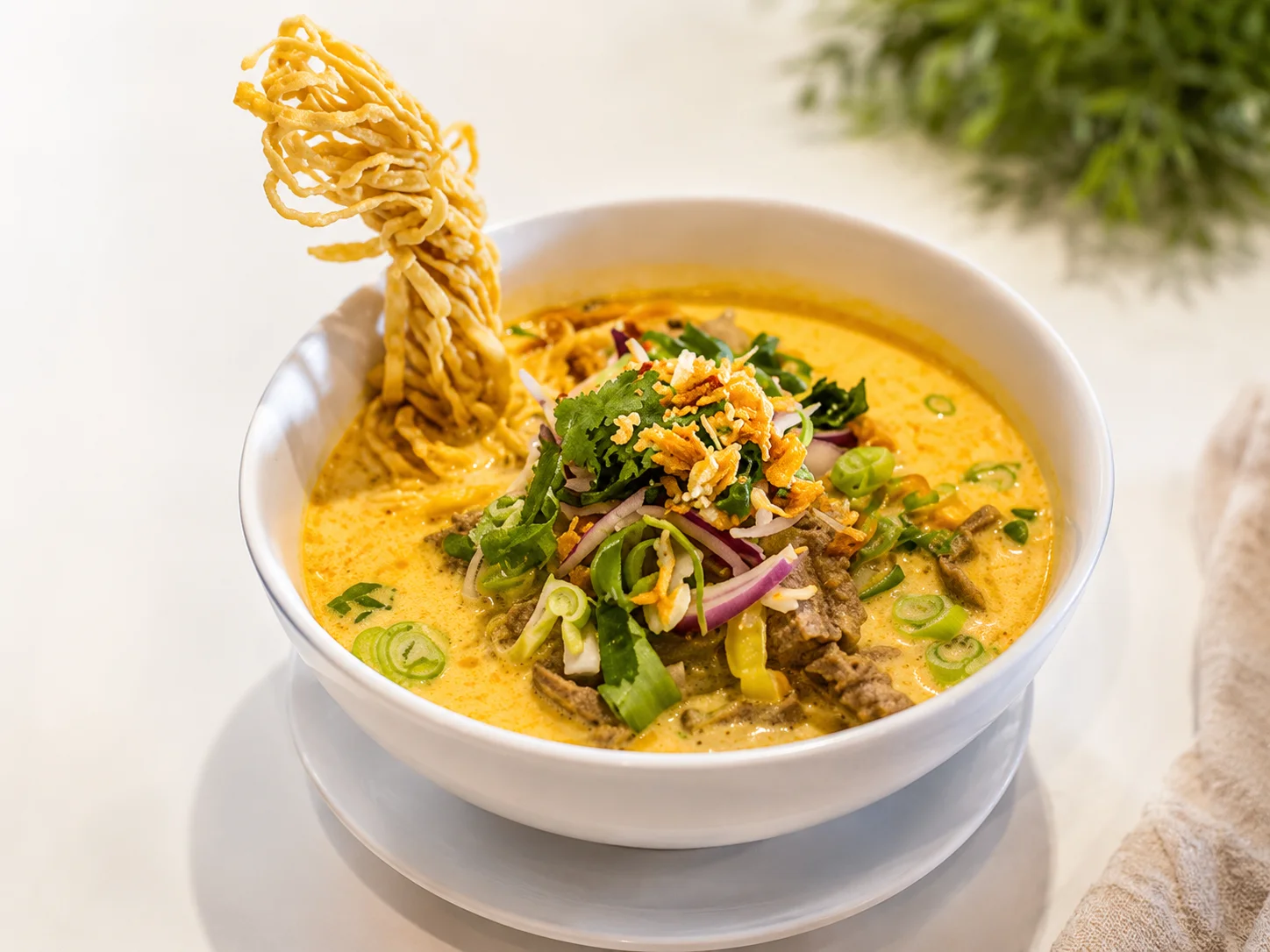 Bowl of Burmese Khao Soi with crispy noodles
